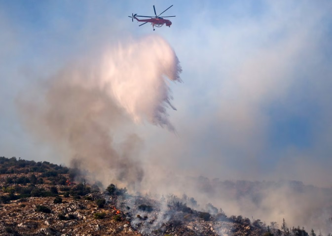 Accused of deliberate arson/The Greek mayor in custody after suspicions that he caused the fire near Athens